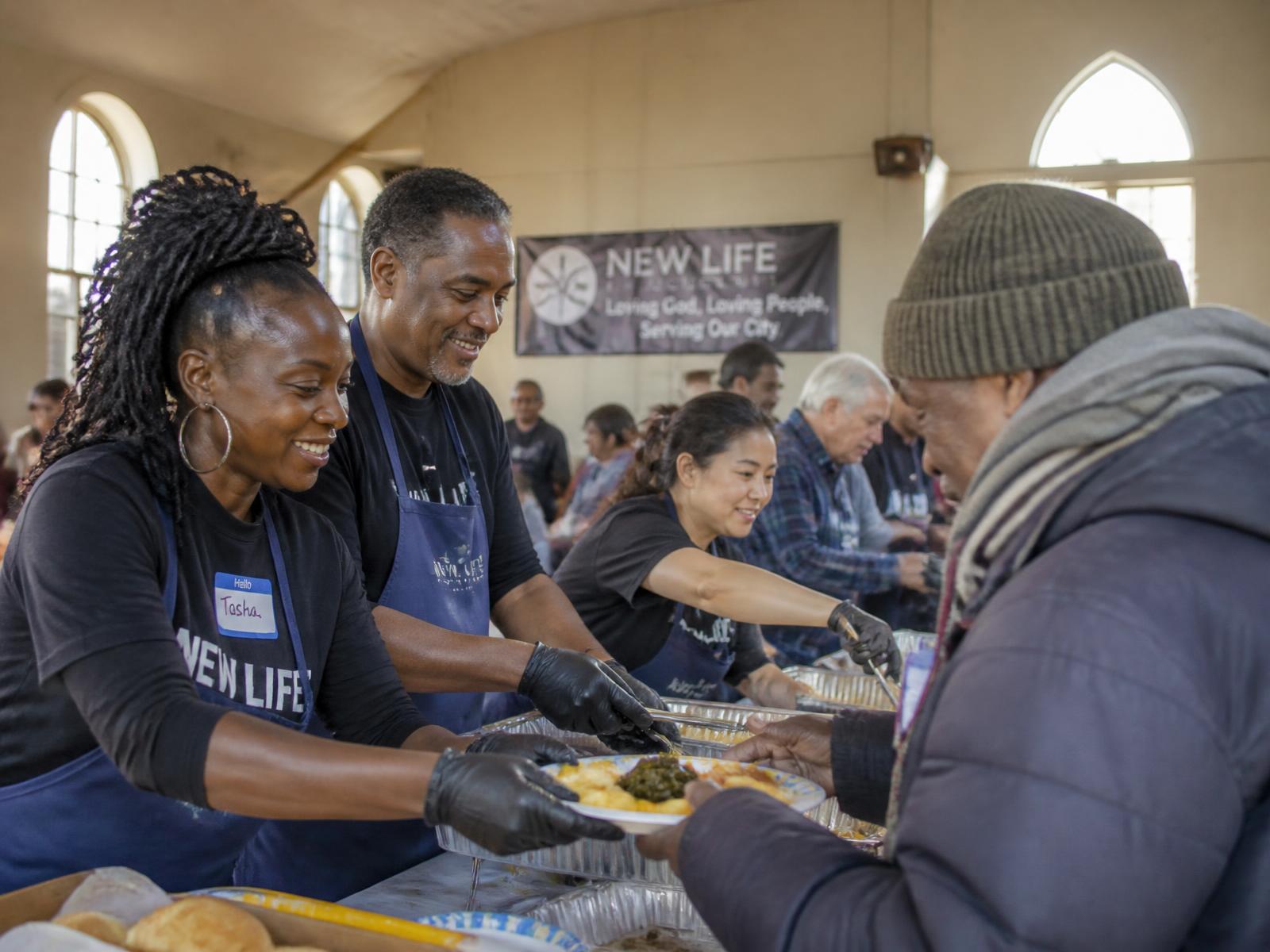 Church volunteers serving meals at a community outreach event