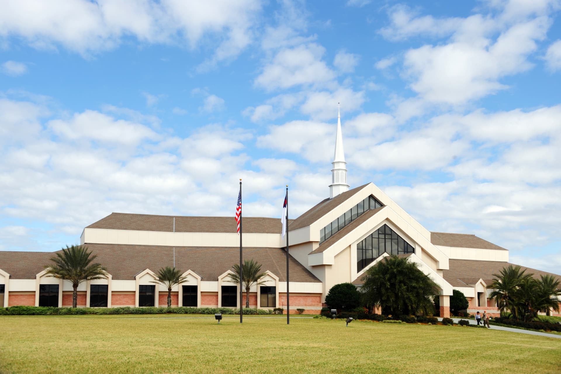 Large church campus with steeple under a blue sky