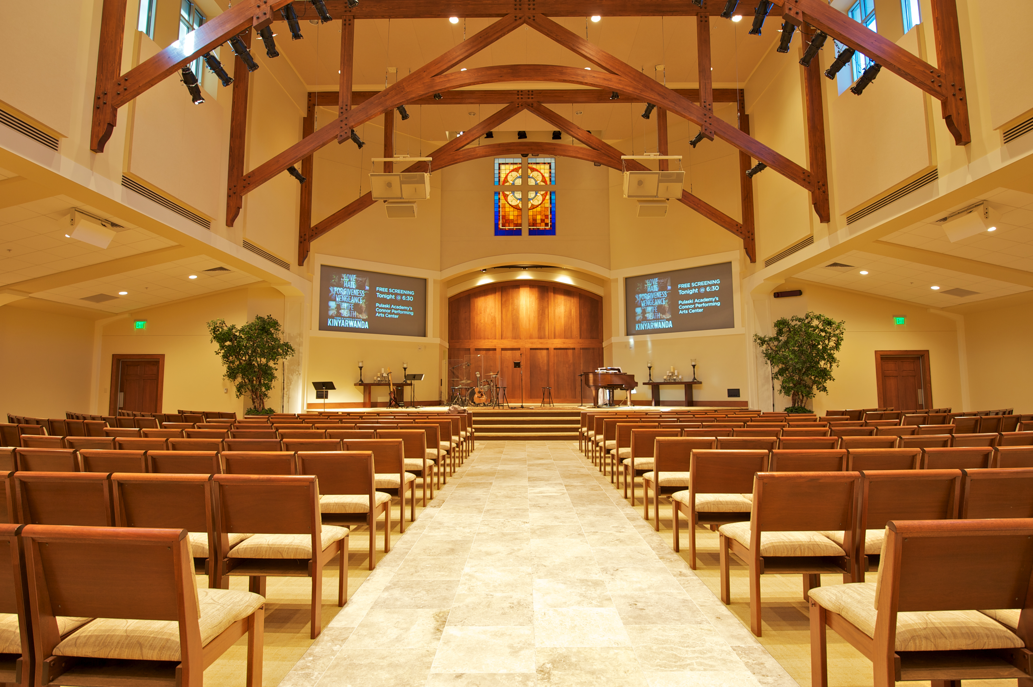 Sunlit sanctuary interior with wooden pews